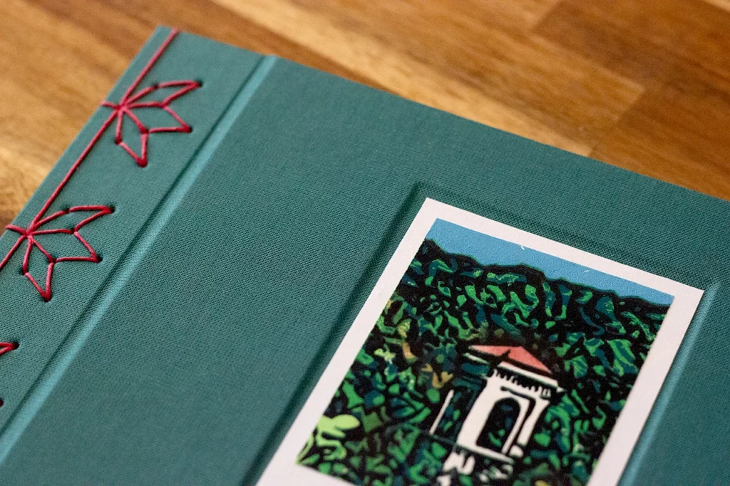 Zoom sur le carnet fait main réalisé lors d’un atelier d’artisanat sur-mesure. On y découvre une linogravure de Laura, précédemment imprimée et intégrée dans une cuvette sur la couverture.