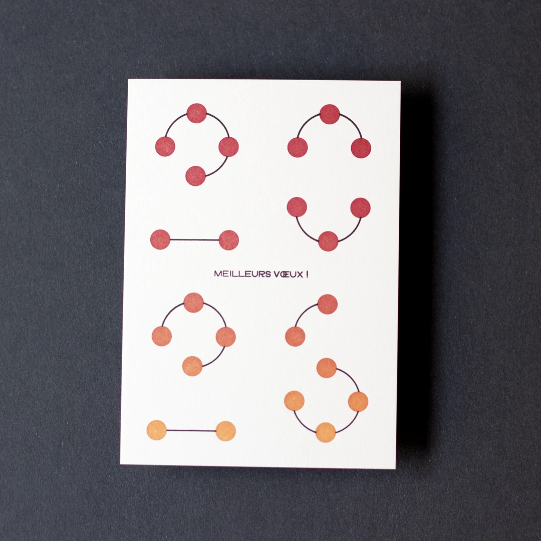 Carte de vœux simple « Planètes 2026 » avec un effet de gradient rouge / jaune soleil en letterpress, avec un fourreau noir, imprimée et façonnée dans mon atelier Forme contre forme.