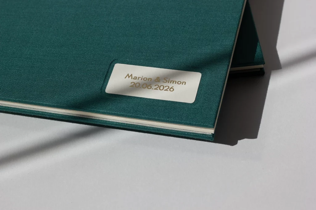 Zoom sur la cuvette en cartonnage du livre d’or avec cartel, prénom des mariés et dorure à chaud — Atelier Forme contre forme, Bordeaux.